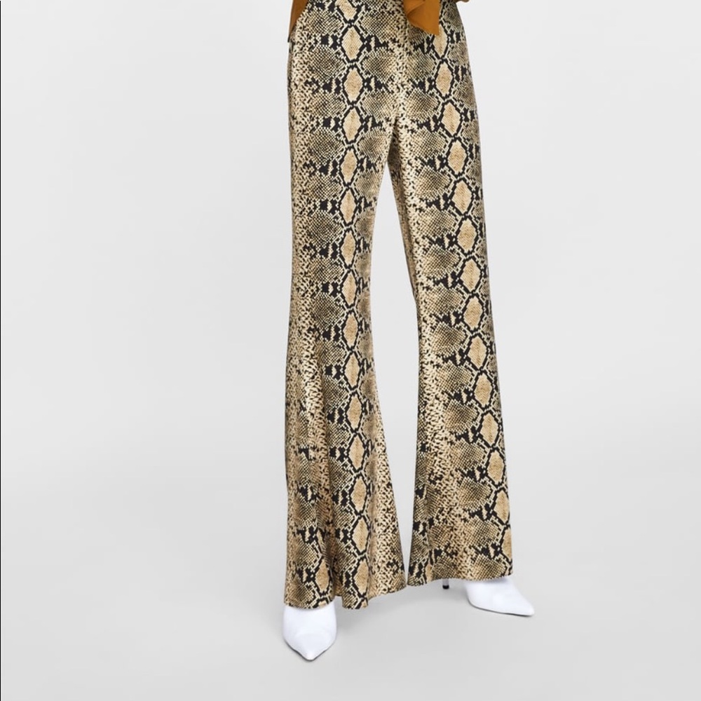 Flared pants with snakeskin print .
